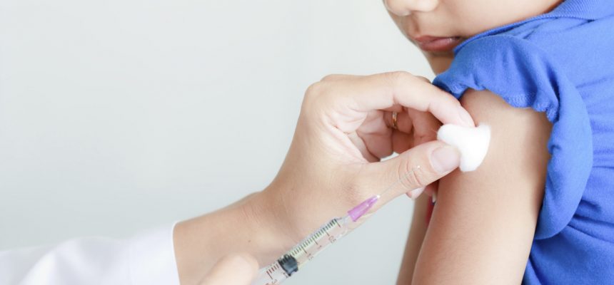 Boy and vaccine syringe