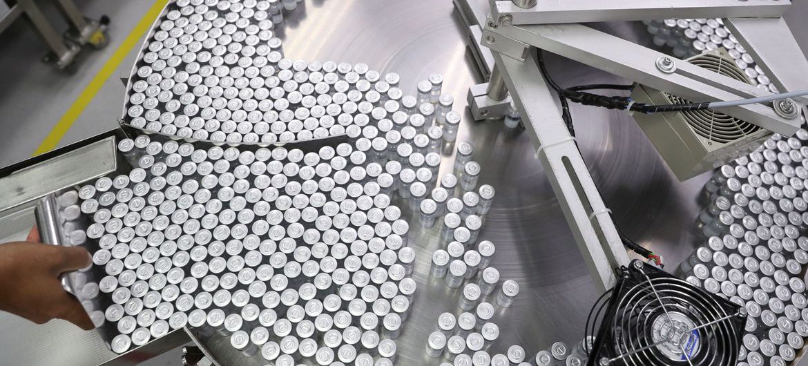 An employee puts on an equipment vials containing CoronaVac, Sinovac's vaccine against the coronavirus disease (COVID-19), at Butantan biomedical production center in Sao Paulo, Brazil January 22, 2021. REUTERS/Amanda Perobelli