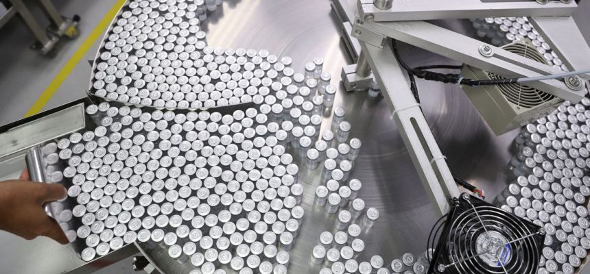 An employee puts on an equipment vials containing CoronaVac, Sinovac's vaccine against the coronavirus disease (COVID-19), at Butantan biomedical production center in Sao Paulo, Brazil January 22, 2021. REUTERS/Amanda Perobelli