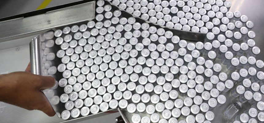 An employee puts on an equipment vials containing CoronaVac, Sinovac's vaccine against the coronavirus disease (COVID-19), at Butantan biomedical production center in Sao Paulo, Brazil January 22, 2021. REUTERS/Amanda Perobelli